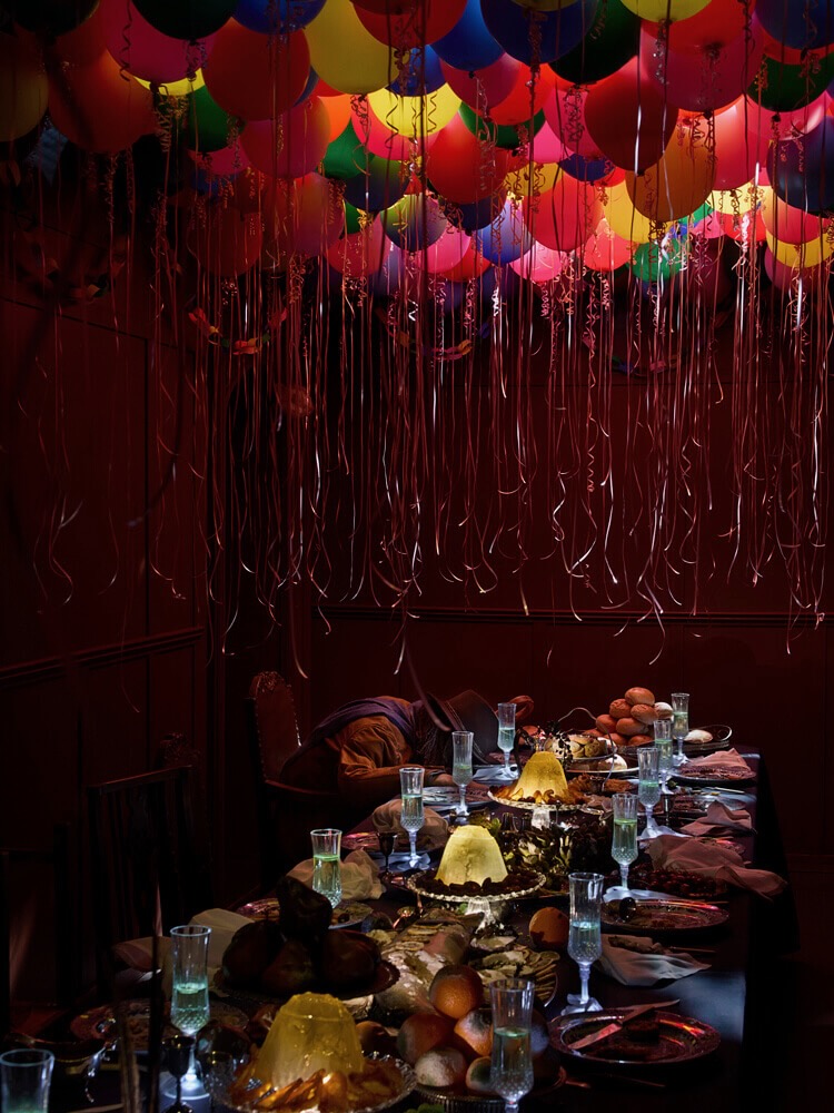 A vibrant table filled with colourful plates and balloons, creating a festive atmosphere in Viola's room.